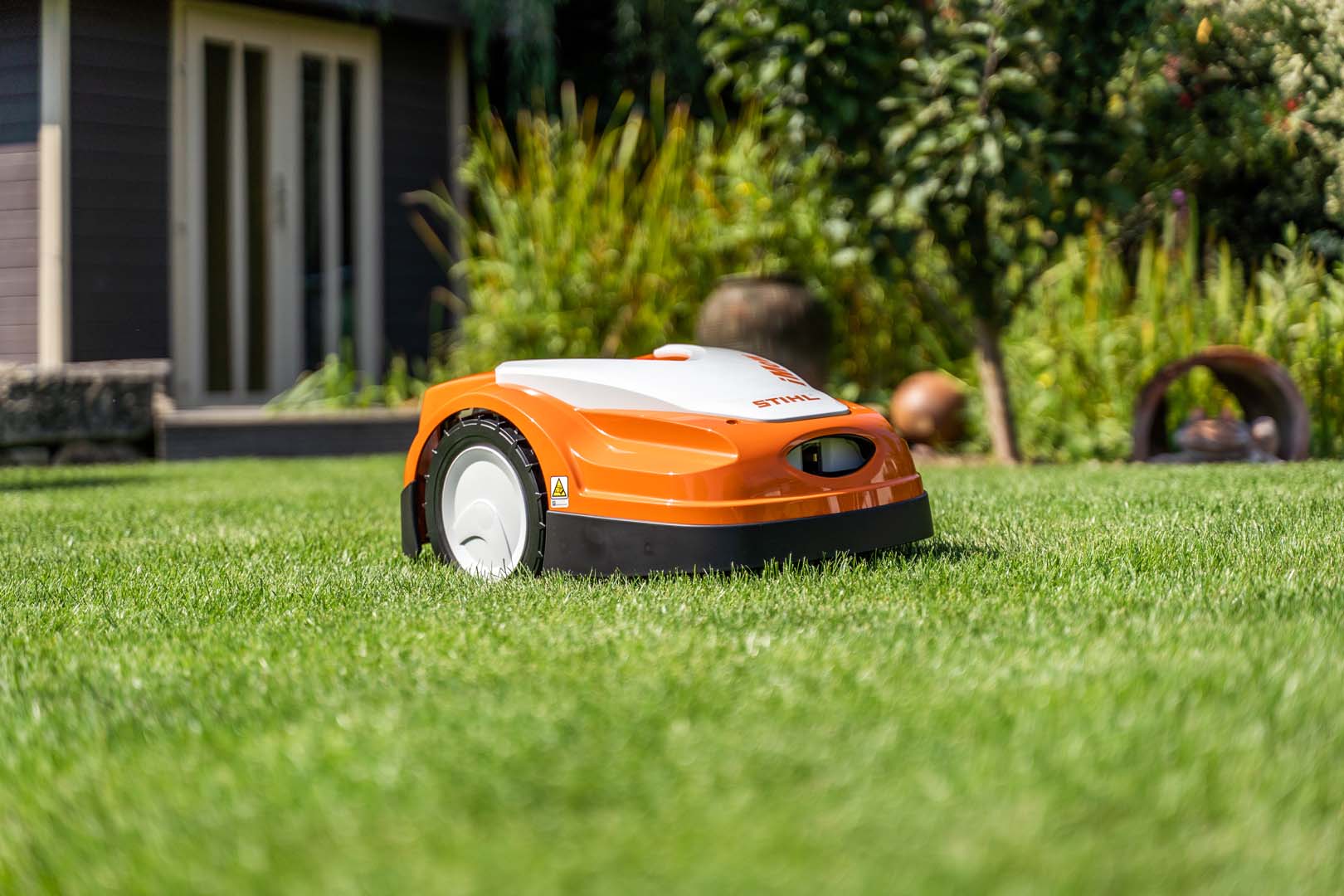 A STIHL iMOW® robot mower in a garden